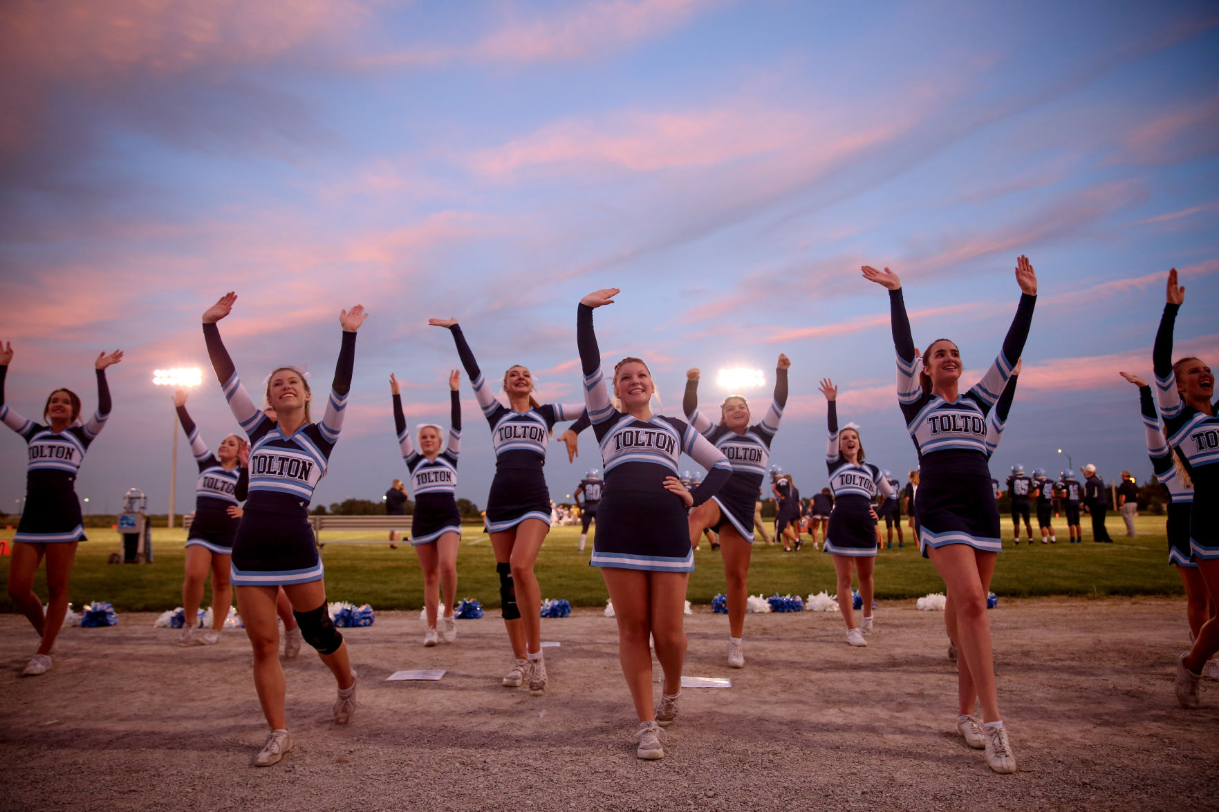 Tolton High School cheerleaders wave to fans
